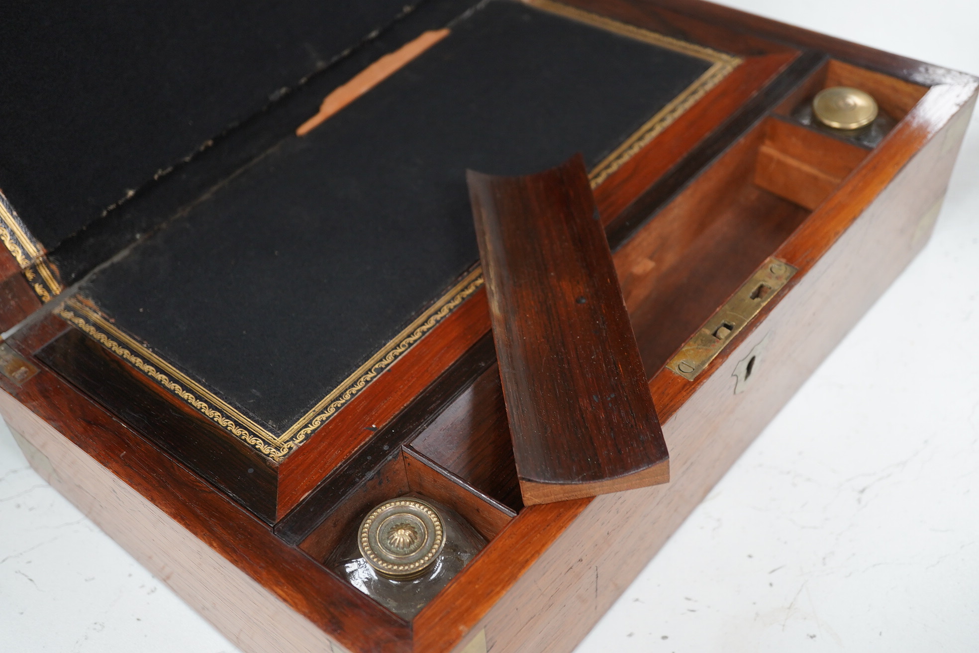 A mahogany brass mounted 19th century writing box and a walnut inlaid and mother of pearl writing box, brass mounted box, 35cm wide. Condition - exterior good, felt on slope torn.